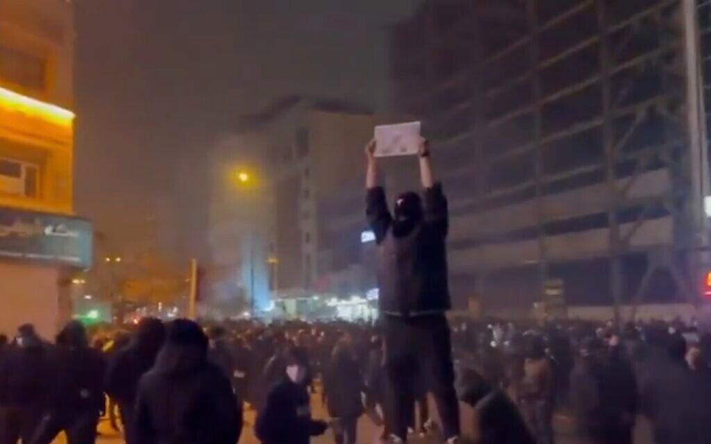An anti-government protester holds up a photo of Reza Pahlavi, the son of the late Iranian shah, during a mass demonstration against the regime in Tehran on January 9, 2026. (Screen capture/X)